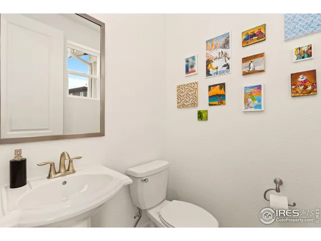 a bathroom with a sink and a white toilet