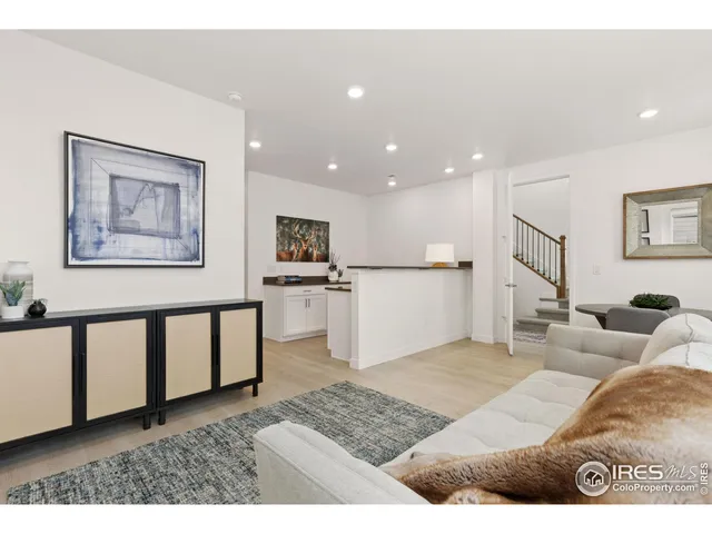 a living room with furniture and a painting