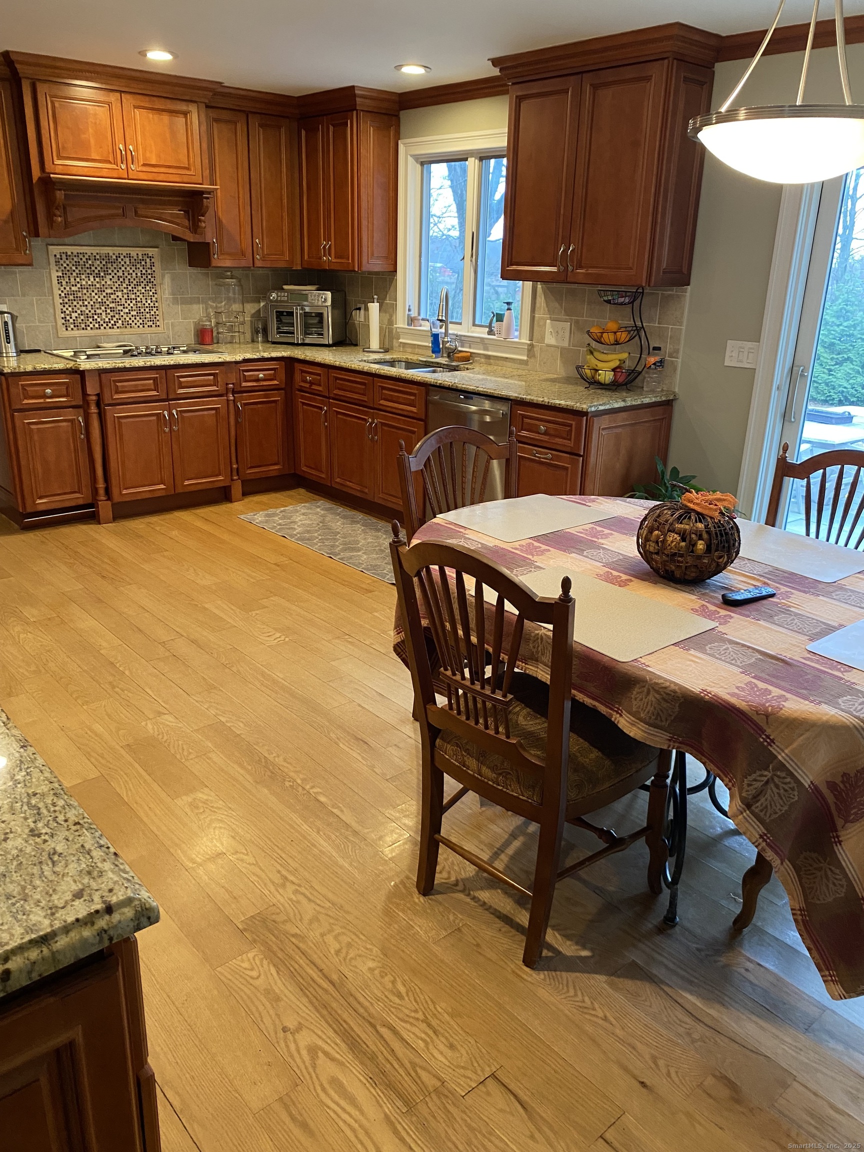 5 Meadow Wood Road Trumbull, CT 06611 - Photo 6 of 20 a kitchen with stainless steel appliances wooden cabinets granite counter tops and a stove