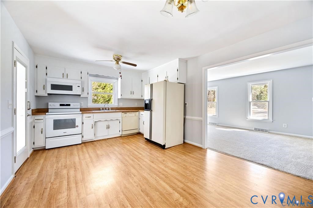 5062 Ruffin Road Prince George, VA 23875 - Photo 7 of 30 The kitchen has laminate flooring and recently pai