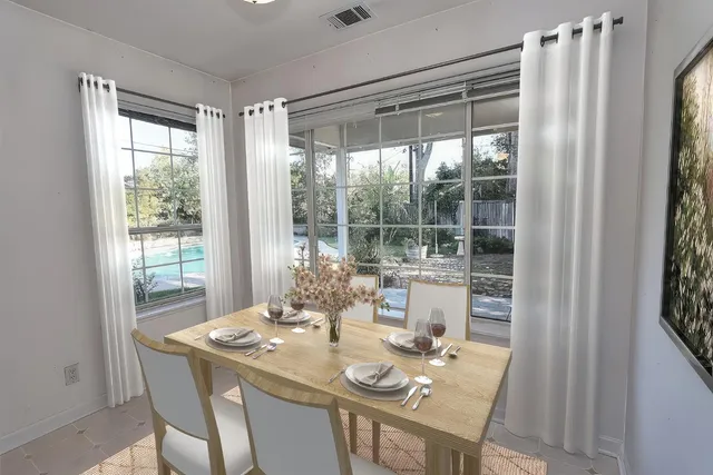 a dining room with furniture and window