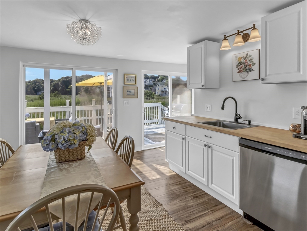 3 Bay View Street Hull, MA 02045 - Photo 13 of 39 a kitchen with a table chairs and a stove
