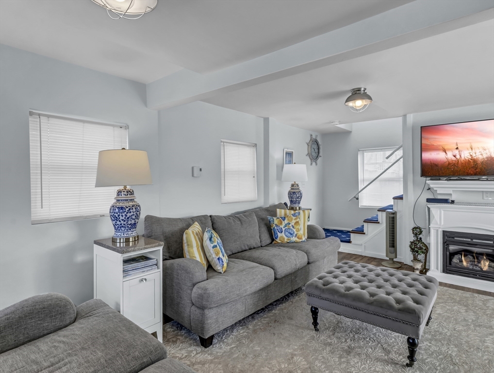 3 Bay View Street Hull, MA 02045 - Photo 15 of 39 a living room with furniture a fireplace and a flat screen tv