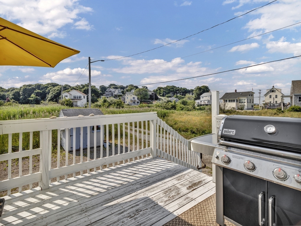 3 Bay View Street Hull, MA 02045 - Photo 19 of 39 a view of a balcony with wooden floor and a floor to ceiling window