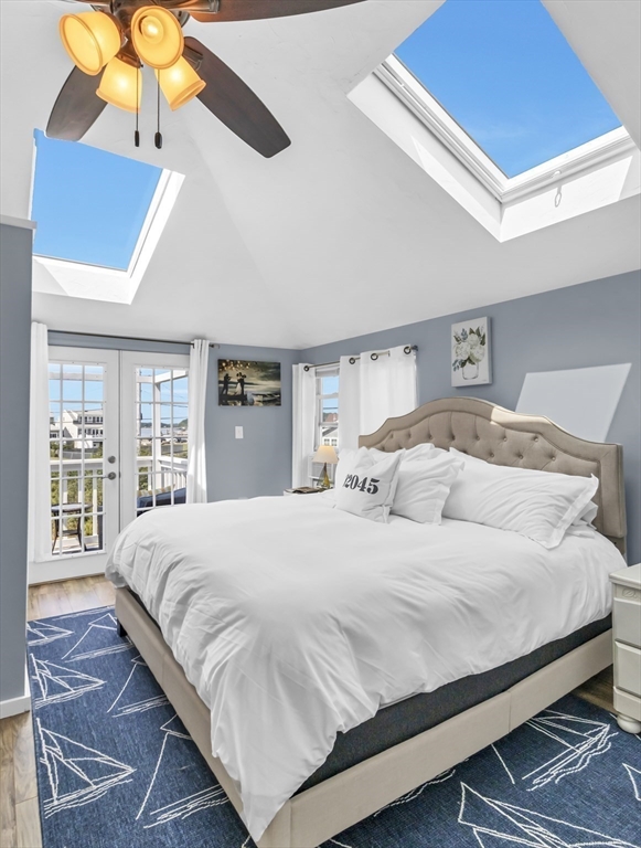 3 Bay View Street Hull, MA 02045 - Photo 27 of 39 a bedroom with a large bed and a chandelier