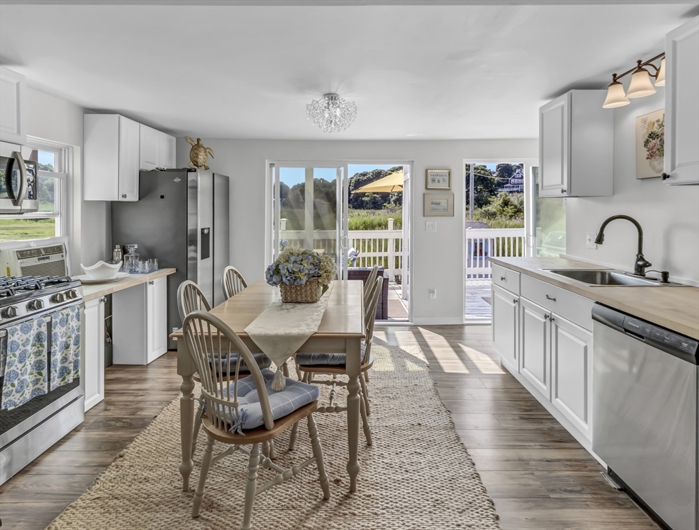 3 Bay View Street Hull, MA 02045 - Photo 10 of 39 a kitchen with stainless steel appliances kitchen island granite countertop a sink and cabinets