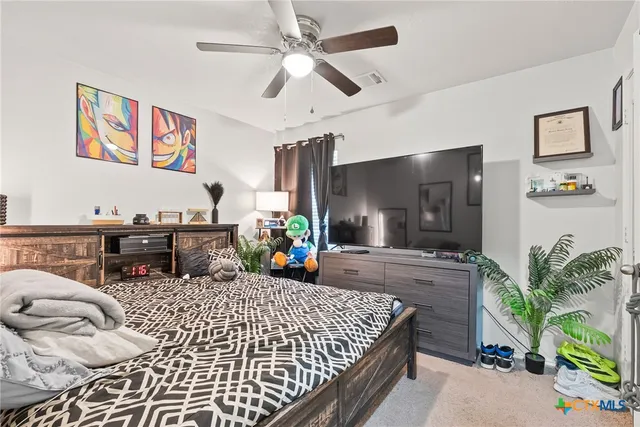 a bed room with a bed window and a chandelier