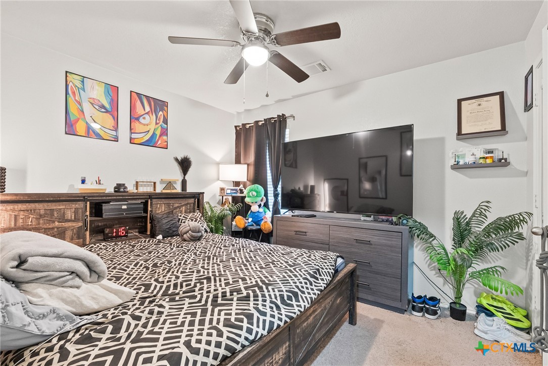 201 Danielle Drive Killeen, TX 76542 - Photo 11 of 16 a bed room with a bed window and a chandelier