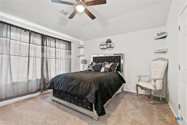 a spacious bedroom with a bed and window