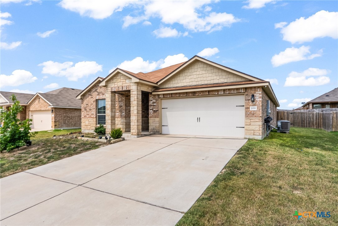 201 Danielle Drive Killeen, TX 76542 - Photo 2 of 16 a front view of a house with a yard and garage