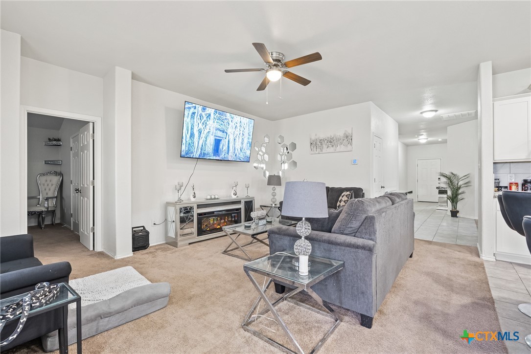 201 Danielle Drive Killeen, TX 76542 - Photo 3 of 16 a living room with furniture a fireplace and a chandelier