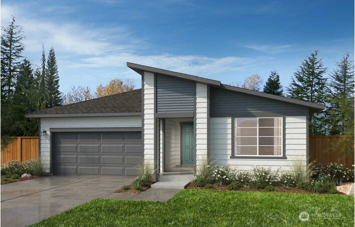 a front view of a house with a garden and yard