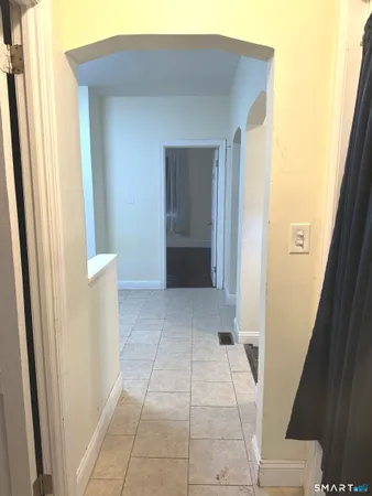 a view of a kitchen from a hallway