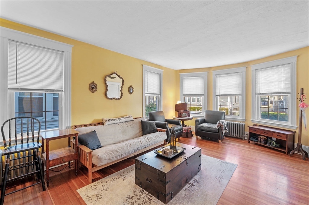 a living room with fireplace furniture and floor to ceiling windows