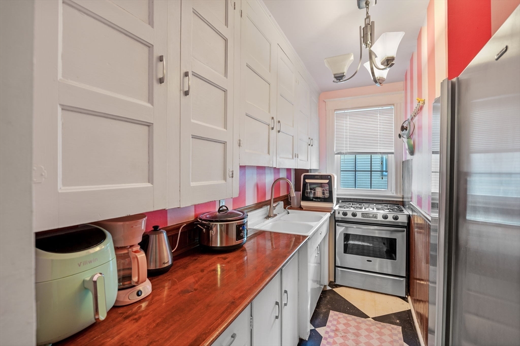 9 Glover Street, Unit 1 Salem, MA 01970 - Photo 18 of 34 a kitchen with stainless steel appliances granite countertop a stove a sink and a refrigerator