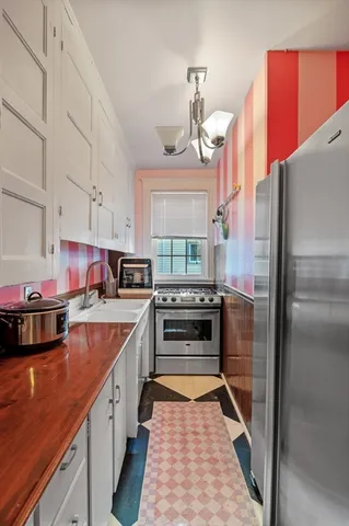 a kitchen with stainless steel appliances granite countertop a stove and a refrigerator
