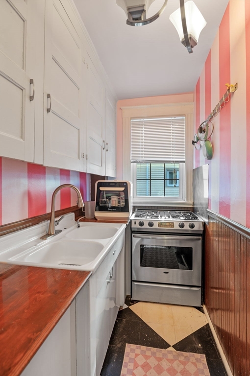 9 Glover Street, Unit 1 Salem, MA 01970 - Photo 20 of 34 a kitchen with stainless steel appliances granite countertop a stove a sink and a microwave