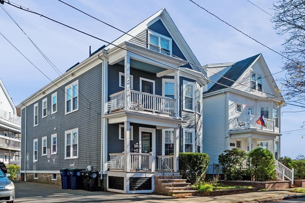 9 Glover Street, Unit 1 Salem, MA 01970 - Photo 2 of 34 a front view of a residential apartment building with a yard