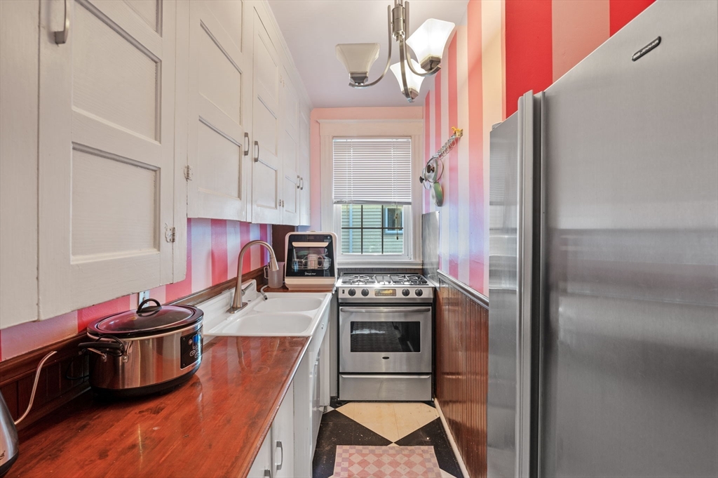 9 Glover Street, Unit 1 Salem, MA 01970 - Photo 21 of 34 a kitchen with stainless steel appliances granite countertop a stove and a refrigerator