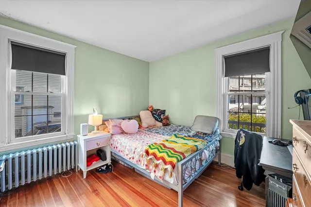 a view of a room with wooden floor and windows