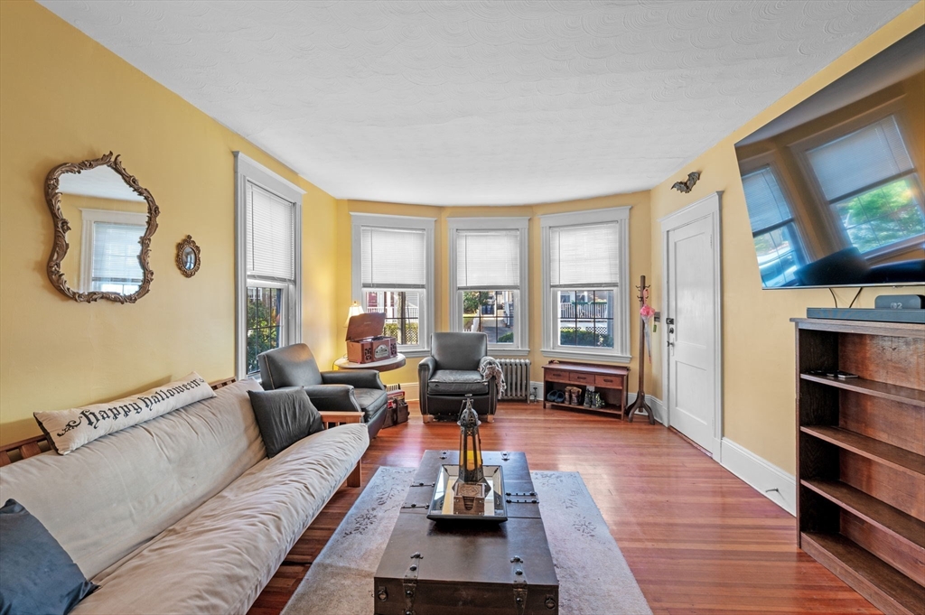 9 Glover Street, Unit 1 Salem, MA 01970 - Photo 6 of 34 a living room with furniture and a flat screen tv