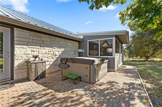 a view of a patio with a table and chairs