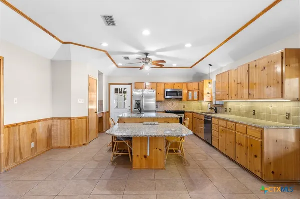 a large kitchen with a table and chairs
