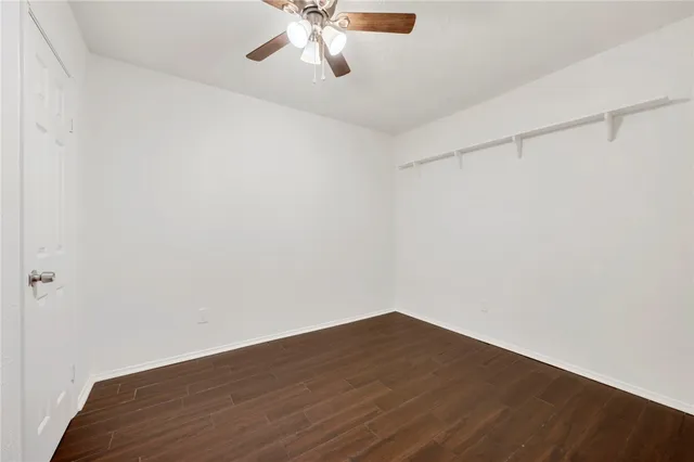 a view of a room with wooden floor and fan
