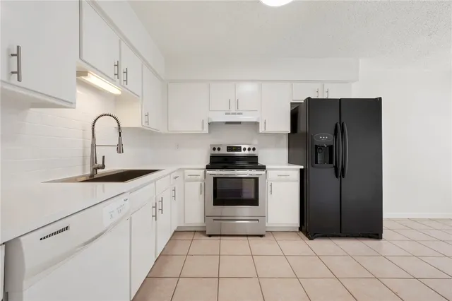 a kitchen with a sink a stove and refrigerator