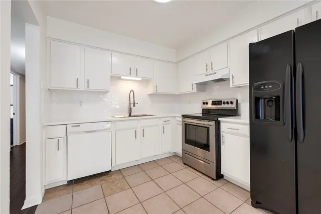 a kitchen with cabinets and stainless steel appliances