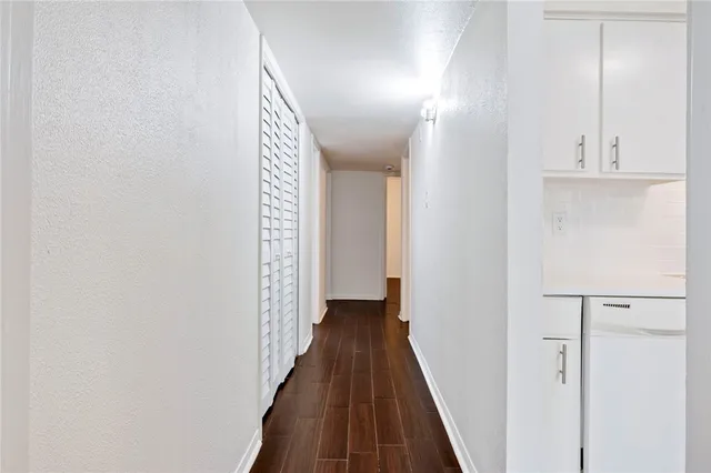 a view of a hallway with wooden floor