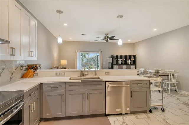 a kitchen with a sink stove and cabinets