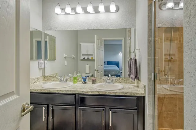 a bathroom with a granite countertop sink a mirror and a vanity