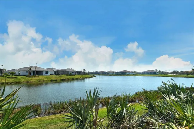 a view of a lake with houses in the back
