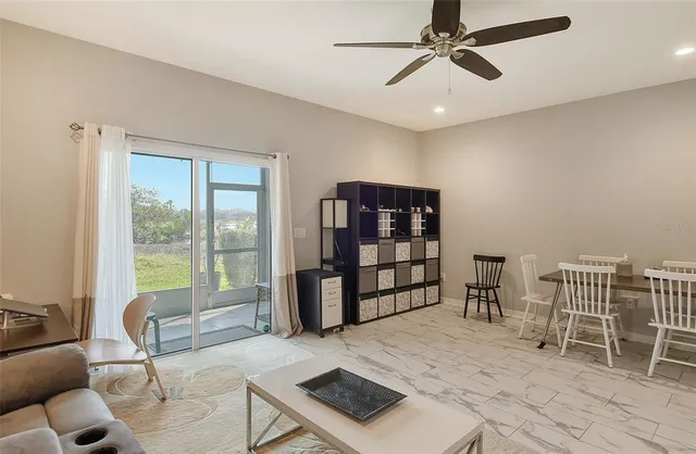 a living room with furniture a flat screen tv and a table