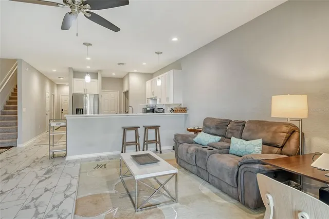 a living room with furniture and kitchen view