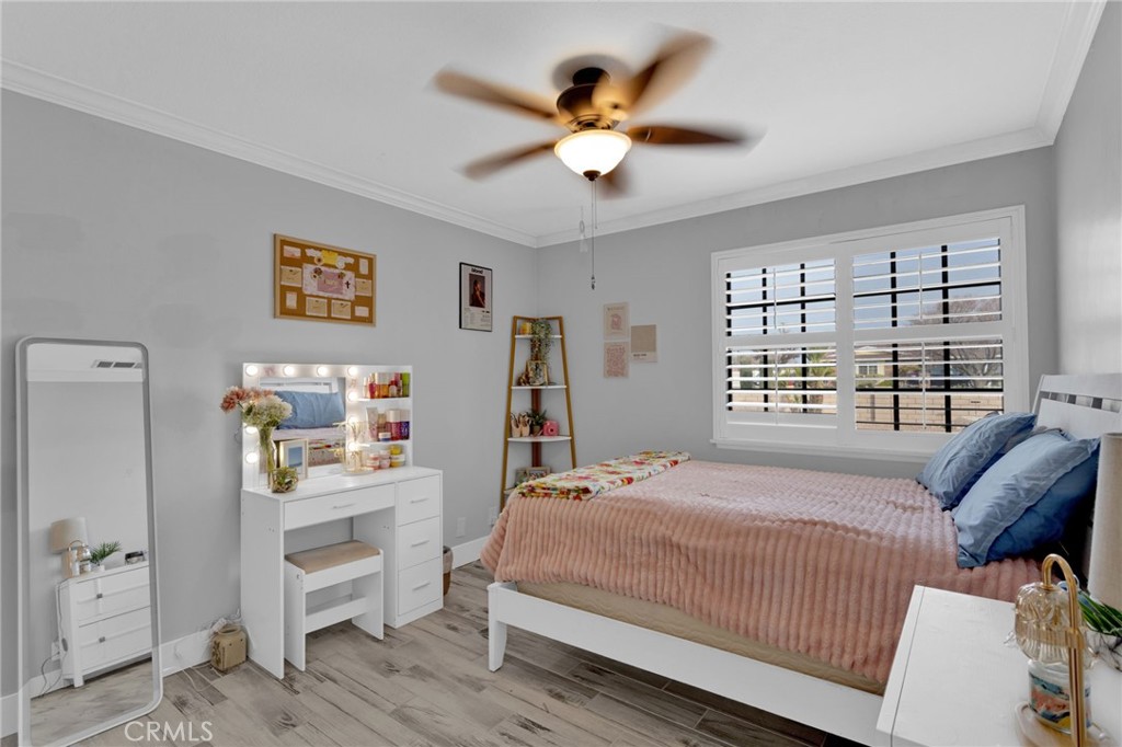 19655 Seneca Road Apple Valley, CA 92307 - Photo 11 of 67 a bedroom with a bed a window and a chandelier