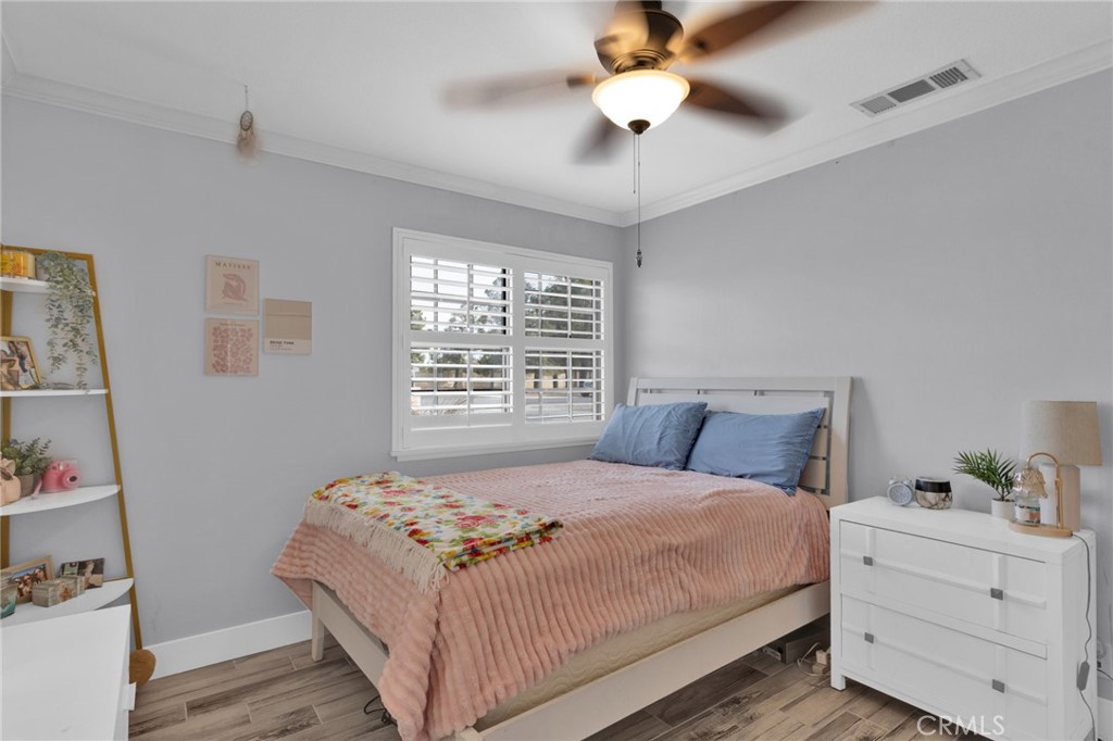 19655 Seneca Road Apple Valley, CA 92307 - Photo 13 of 67 a bedroom with a large bed and a window