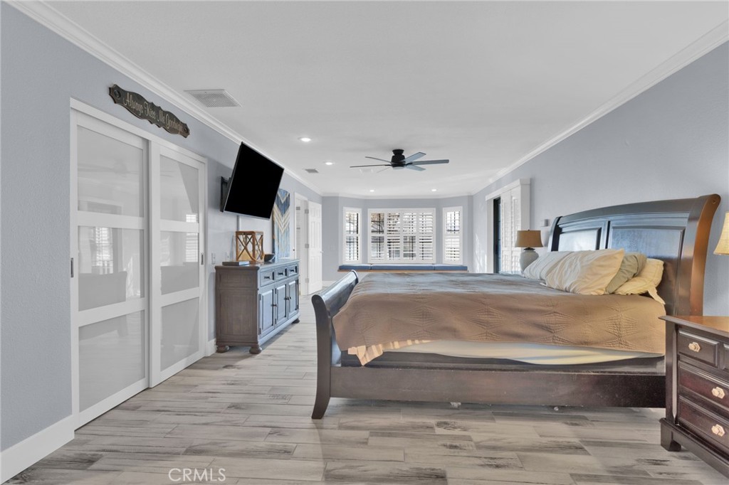 19655 Seneca Road Apple Valley, CA 92307 - Photo 19 of 67 a spacious bedroom with a bed and a flat screen tv