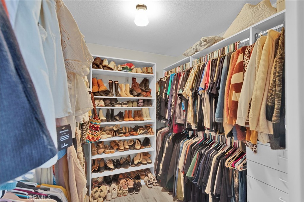 19655 Seneca Road Apple Valley, CA 92307 - Photo 22 of 67 a view of walk in closet with clothes and shoes