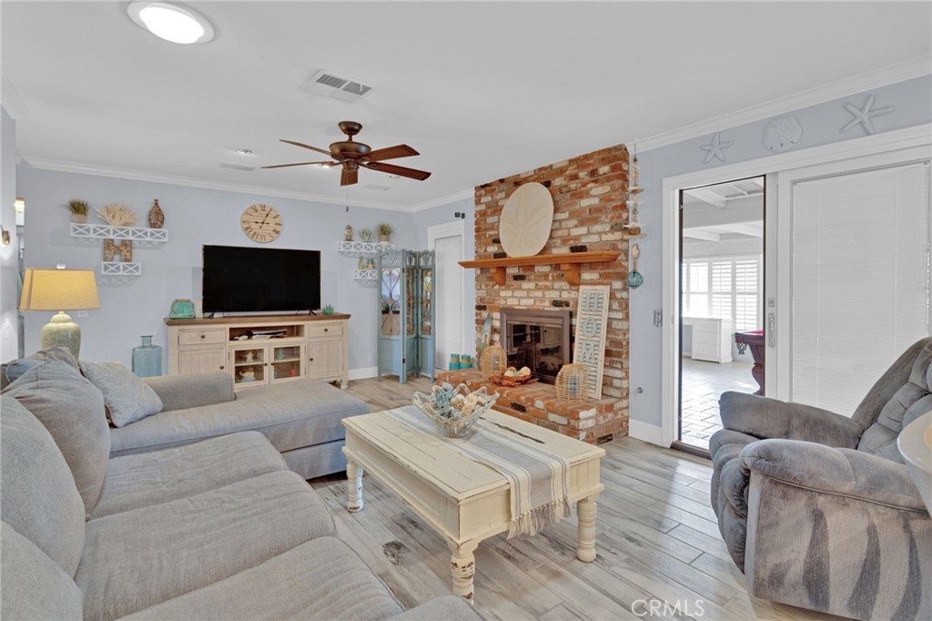 19655 Seneca Road Apple Valley, CA 92307 - Photo 32 of 67 a living room with furniture a flat screen tv and a fireplace