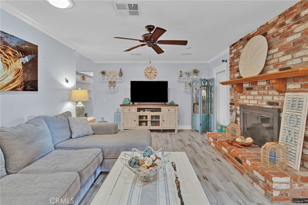 19655 Seneca Road Apple Valley, CA 92307 - Photo 34 of 67 a living room with furniture a fireplace and a flat screen tv