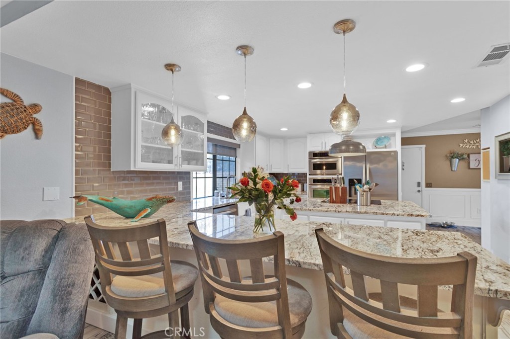 19655 Seneca Road Apple Valley, CA 92307 - Photo 38 of 67 a view of a dining room with furniture and a chandelier