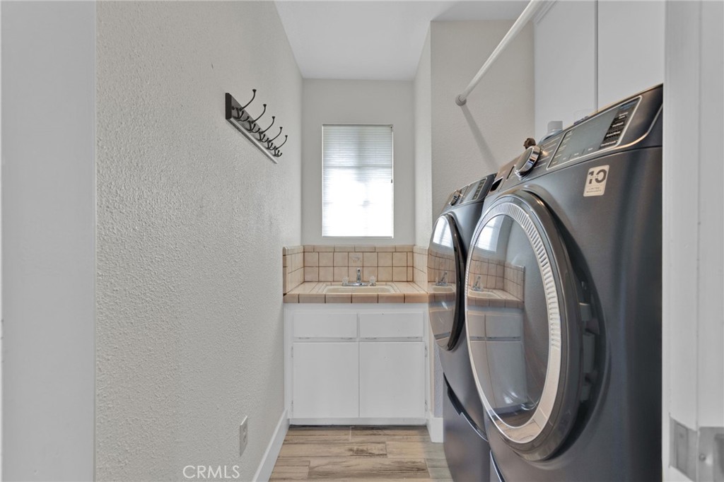 19655 Seneca Road Apple Valley, CA 92307 - Photo 45 of 67 a view of a storage and utility room with washer and dryer