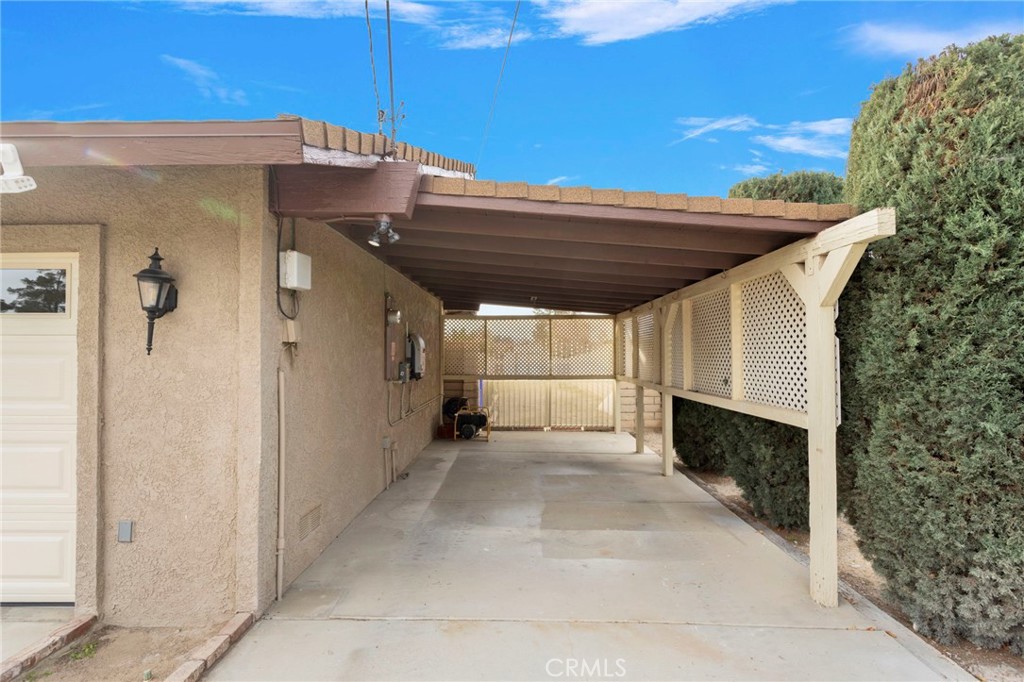 19655 Seneca Road Apple Valley, CA 92307 - Photo 5 of 67 a view of a patio with table and chairs under an umbrella with a small yard
