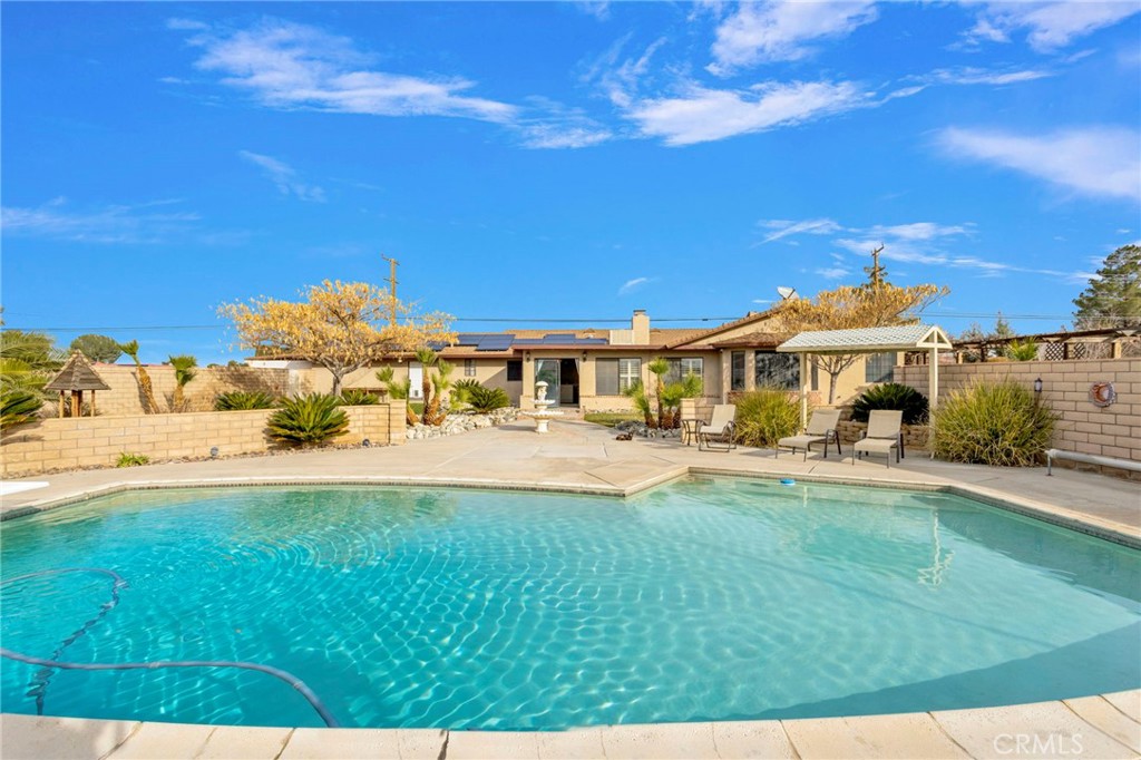 19655 Seneca Road Apple Valley, CA 92307 - Photo 52 of 67 a front view of a house with swimming pool having outdoor seating