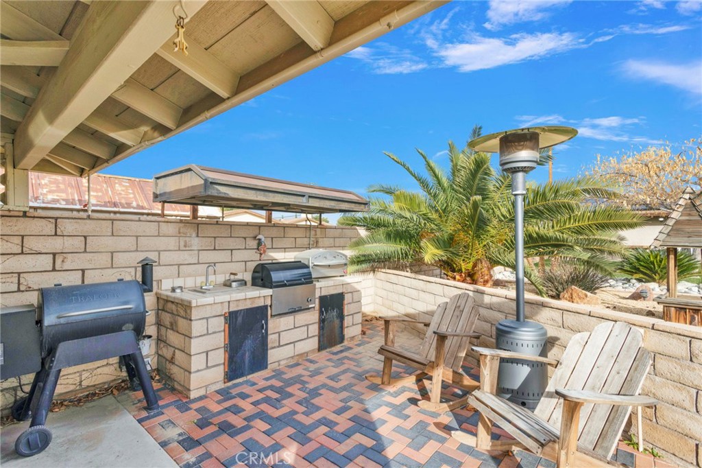19655 Seneca Road Apple Valley, CA 92307 - Photo 55 of 67 a view of a patio with a table and chairs and potted plants