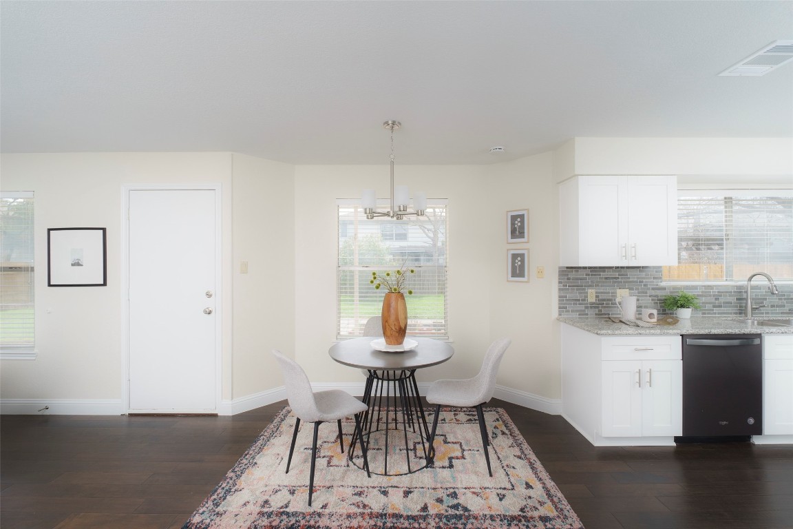 2201 Broughton Court Austin, TX 78727 - Photo 12 of 31 a dining room with wooden floor and a chandelier