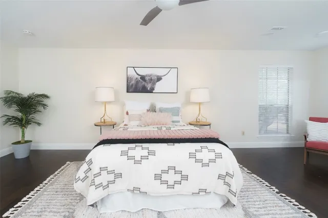 a bedroom with a bed and a potted plant