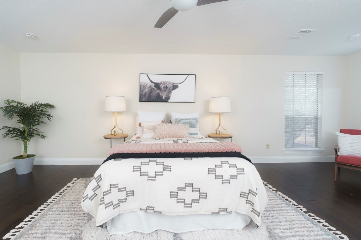 2201 Broughton Court Austin, TX 78727 - Photo 14 of 31 a bedroom with a bed and a potted plant